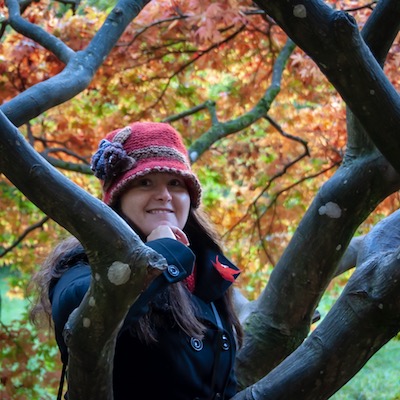 My Autumn Bucket List To Welcome In The New Season, Corinna surrounded by autumnal trees at the arboretum